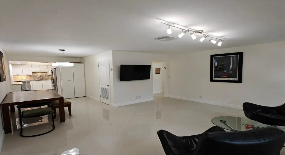 Spacious with natural lighting, impact windows, TV attached to the wall.