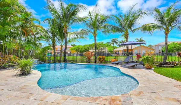 Spectacular backyard oasis with salt-water pool, equipped tiki-hut & waterfront views.