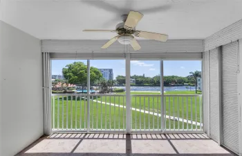 Large and spacious living room with amazing water views of main intracoastal and sliders to screened patio - staged photo