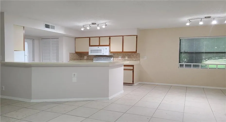 KITCHEN AND DINING ROOM. NEW KITCHEN APPIANCES, FRESHLY PAINTED NEW CLOSET DOORS THROUGHOUT AND NEW BLINDS