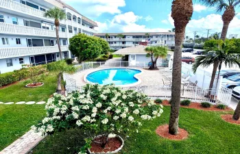 Serene view of the pool and courtyard from your screened porch.