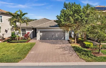 Gorgeous curb appeal and ample pavered driveway greet you