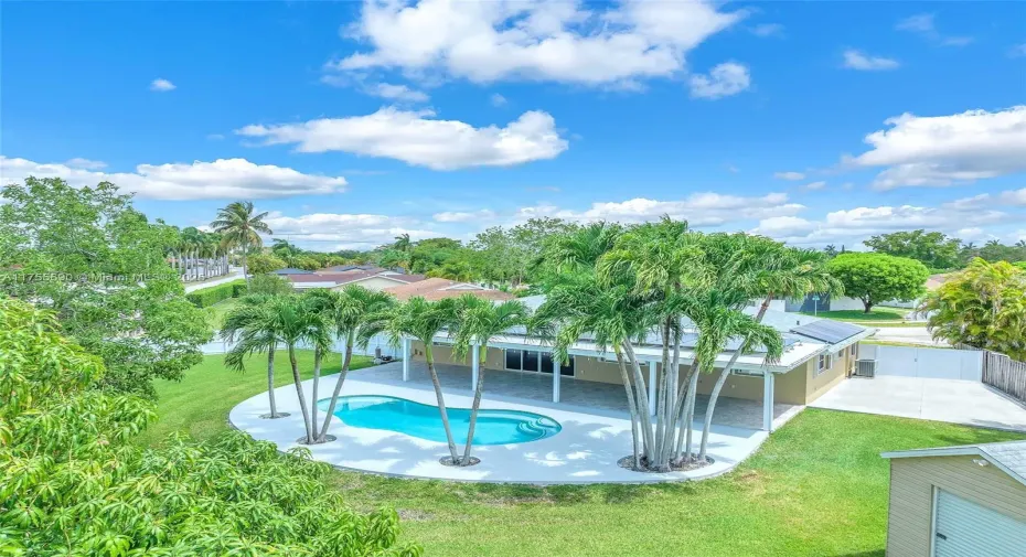Beautiful oasis with a saltwater pool and a concrete slab behind gates for a boat/RV