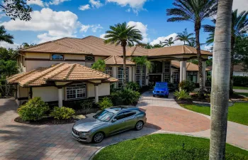 Grand circular driveway, porte-cochere entryway, situated on an oversized private acre-plus lot with waterfront along rear property line