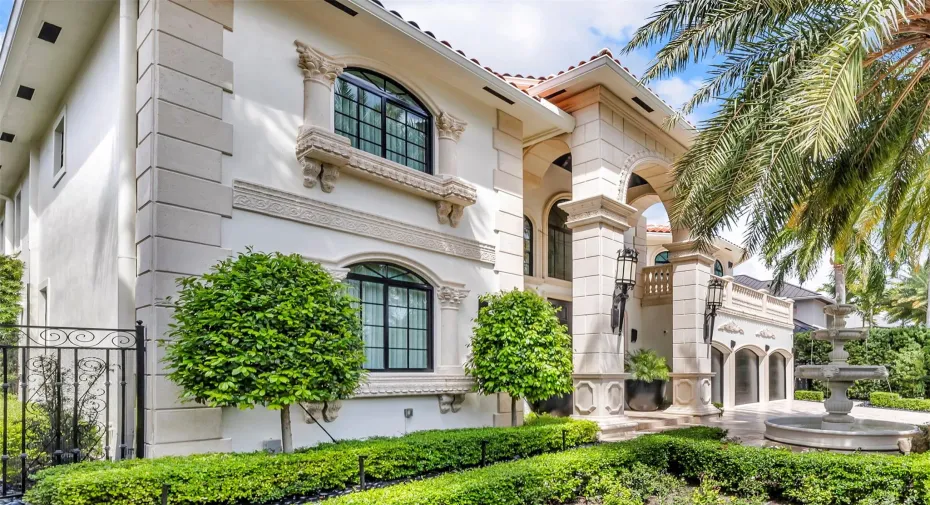 A lushly landscaped courtyard, bathed in automated lighting and centered around a dramatic 10-foot lion head fountain creates an unforgettable first impression, setting the tone for the effortless luxury that unfolds inside.