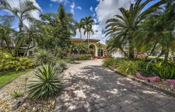 Lush landscaping adorns the front of the home.